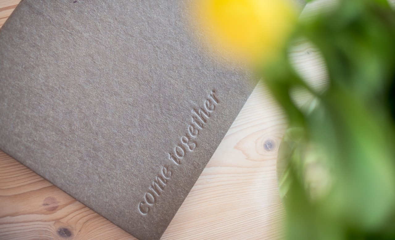 Menü-Folder im Hotel Masatsch mit Come-Together-Schriftzug