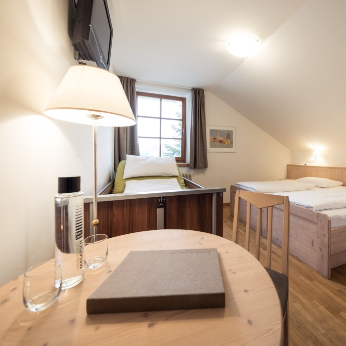 Hotelzimmer im Hotel Masatsch mit Holztisch und Holzstuhl